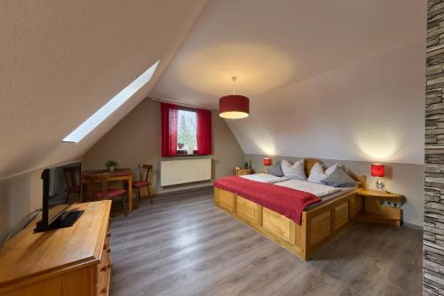 Kammerforst布劳纳赫希乡村酒店的一间卧室配有一张床,并在一间客房内配有电视。