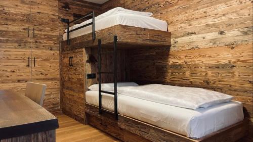 圣坎迪朵Appartments Raffele的木墙客房的两张双层床