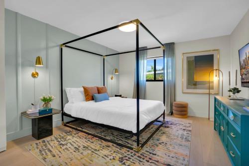 迈阿密Miami GEM的一间卧室配有一张天蓬床和地毯。
