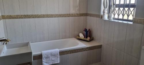 约翰内斯堡The Throne的白色的浴室设有浴缸和水槽。