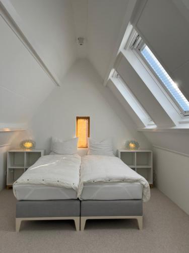 诺德韦克Aventure的阁楼设有1间带1张床的卧室,配有天窗