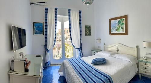 波西塔诺Hotel Villa Delle Palme in Positano的一间卧室设有一张床和一个窗口