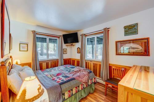 玛瑙湾Peaceful Forest Retreat的一间卧室设有一张床和两个窗户。