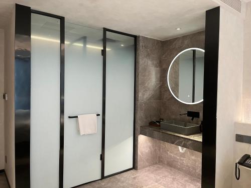 西安忆宿石玖设计师酒店(西安钟鼓楼回民街店)的一间带镜子和水槽的浴室