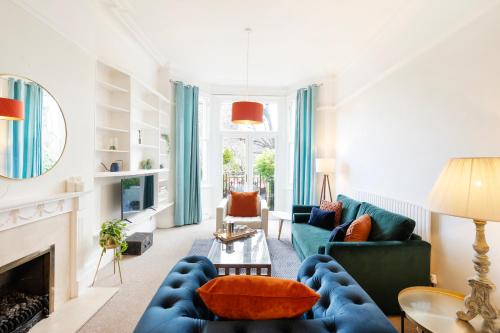 布里斯托Spacious and quiet ground floor flat的客厅设有蓝色的沙发和壁炉