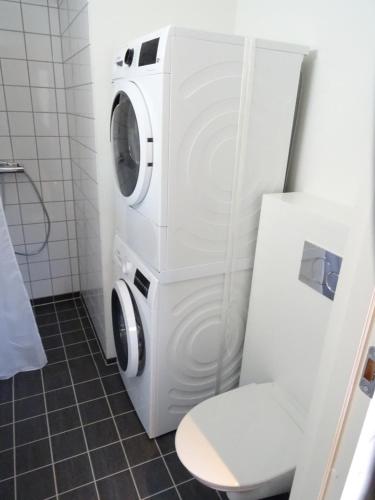 SandurCaptains Cottage的带卫生间的浴室内的洗衣机和烘干机