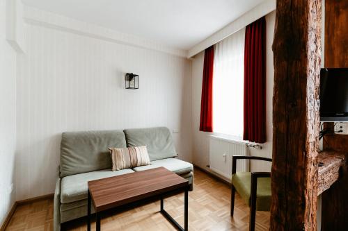 罗滕堡金吉瑞芬酒店的客厅配有沙发和桌子
