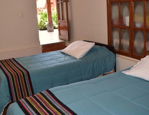 卡哈马卡Casa Pablo的两张睡床彼此相邻,位于一个房间里