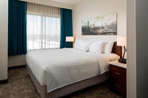 林肯郡芝加哥林肯郡斯普林黑尔套房酒店的一间卧室设有一张床和一个大窗户