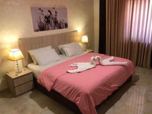 安曼Suzan Hotel Apartments的一间卧室配有一张床,上面有两条毛巾