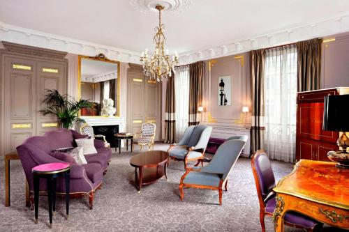 巴黎The Westin Paris - Vendôme的客厅配有紫色家具和吊灯。