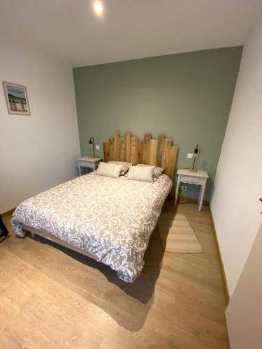 圣吕奈尔L'Escale Marine的一间卧室配有一张带木制床头板的床