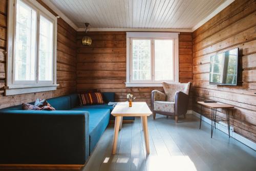 伯Breiva Gjestegaard og Glamping的客厅配有蓝色的沙发和桌子