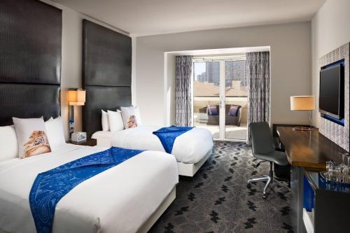 达拉斯达拉斯维多利W酒店的酒店客房配有两张床和一张书桌