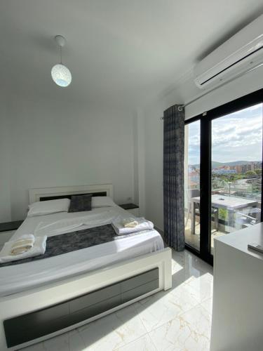 卡萨米尔Villa Mucodemi 1的一间卧室设有一张床和一个大窗户