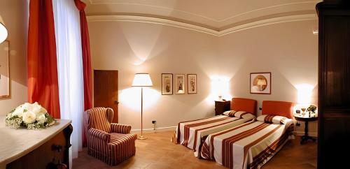 佛罗伦萨帕拉索阿法尼德波卡住宅酒店的配有一张床和一把椅子的酒店客房