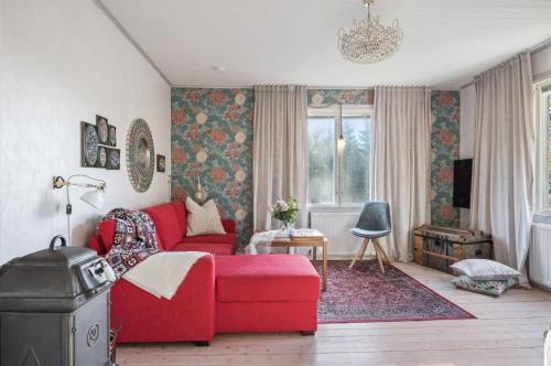 斯特伦斯塔德The Solhem Cabin的客厅设有红色的沙发和窗户。