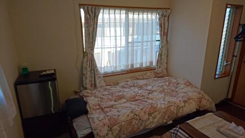 TorideToride - House / Vacation STAY 4015的卧室在窗户前配有一张床