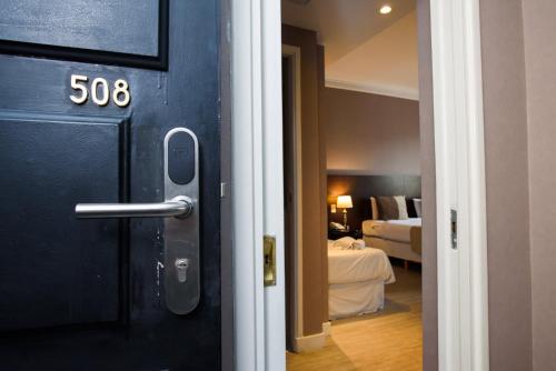 布宜诺斯艾利斯1253 Recoleta Small Hotel的通往卧室和床的房间的门