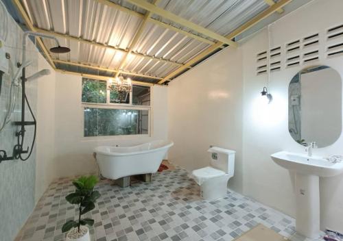 แม่ไพโฮมสเตย์ ล่องแพกอนโดล่า的带浴缸、卫生间和盥洗盆的浴室