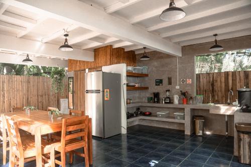 圣塔特蕾莎海滩Zeneidas Surf Garden的厨房配有木桌和冰箱。