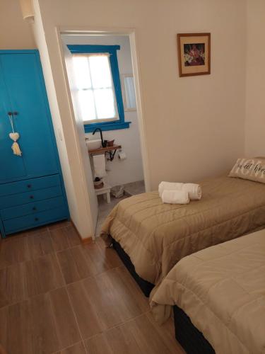 布宜诺斯艾利斯Aristobulo的一间卧室设有两张床和蓝色的橱柜