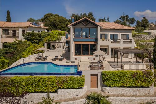 费斯卡尔德宏Luxury Villa Karmaniolos Fiskardo Kefalonia的一座带游泳池和房子的度假屋