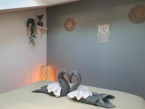 沃韦Riviera Guest house - Private room in a shared appartment的两只天鹅用毛巾制成,坐在床上