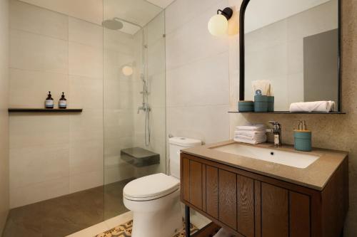 勒吉安The Mahata的浴室配有卫生间、盥洗盆和淋浴。