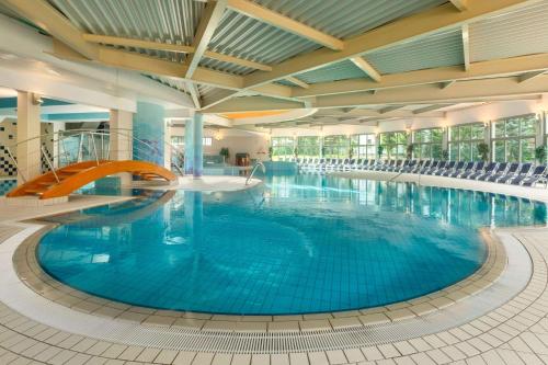 克拉尼斯卡戈拉克拉尼斯卡戈拉华美达度假酒店的大楼内一个蓝色的大型游泳池