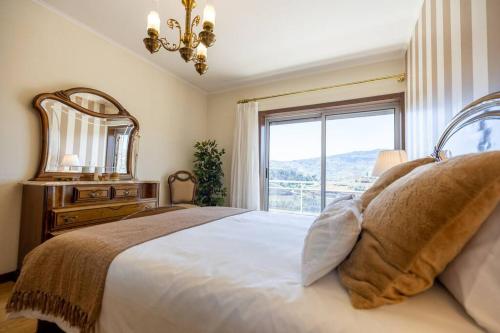 比索达雷加Casa da Tia Douro的一间卧室设有一张大床和大窗户