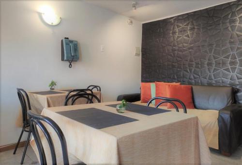 安托法加斯塔Hostal valle de la luna的客厅配有两张桌子和一张沙发