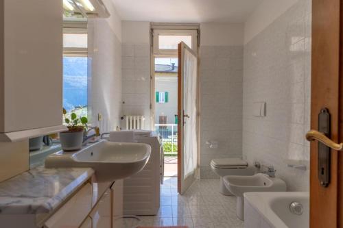 莱维科特尔梅Casa Agnese, Levico Terme - Ospitar的一间带两个盥洗盆、浴缸和卫生间的浴室
