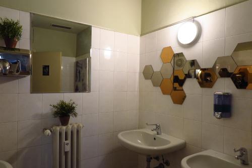 米兰考拉旅舍的一间带水槽、镜子和散热器的浴室