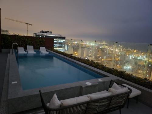利马¡Una escapada relajante en Lima!的建筑物屋顶上的游泳池