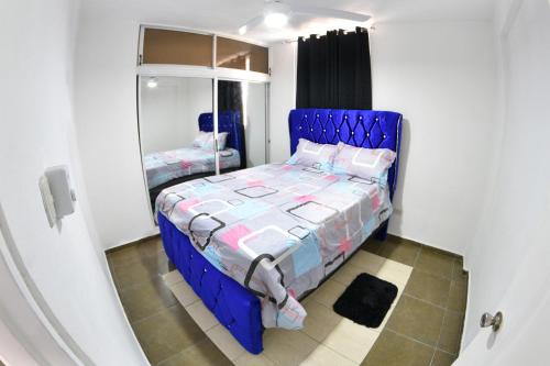 圣地亚哥洛斯卡巴las carreras centro D la ciudad的一张蓝色的床,位于带镜子的房间里