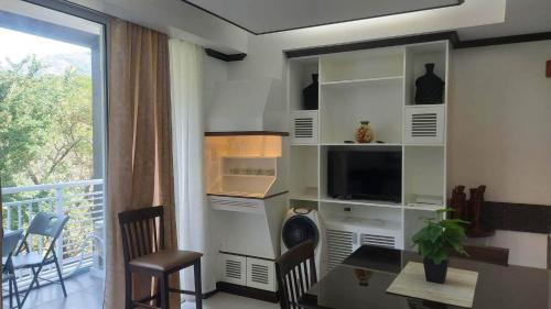 PapayaPico de Loro Myna A 510的客厅配有餐桌和电视