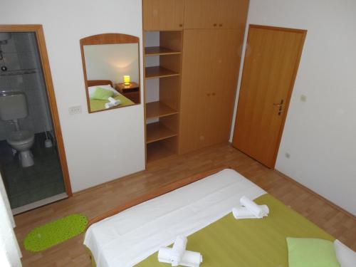 赫瓦尔克瓦西奇公寓的卧室配有白色的床和镜子