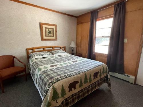 Rapid RiverHillcrest Inn & Motel的一间卧室设有一张床和一个窗口