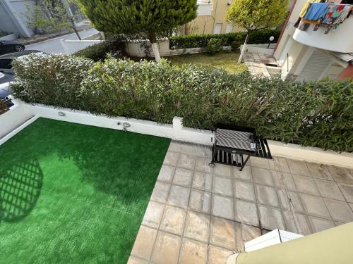 佩科霍里Bella Maisonette的享有带2张长椅的绿色庭院的顶部景色