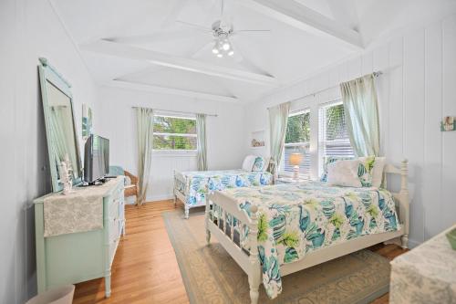 萨拉索塔Beach Side Babe的一间卧室设有两张床、一台电视和窗户。