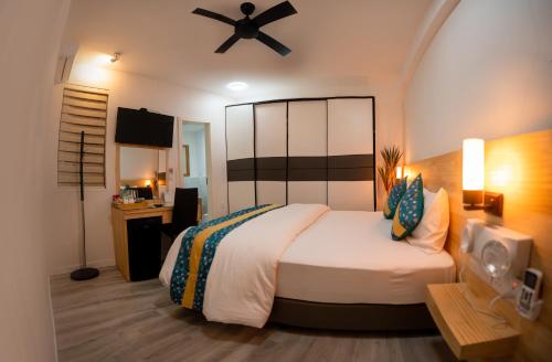 马累Tourist Inn Grand的一间卧室配有一张床和吊扇