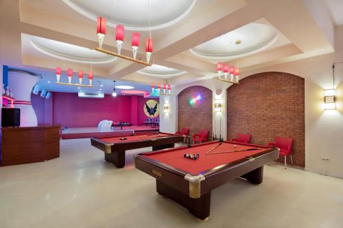 欧库卡拉Granada Luxury Okurcalar的一个带两张台球桌和红色椅子的泳池房
