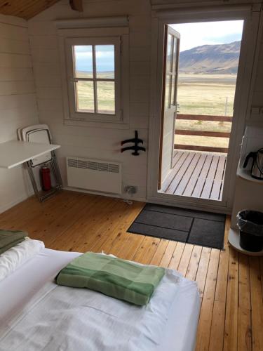 布扎达吕尔Seljaland ferðaþjónusta的一间卧室设有一张床和一个大型滑动玻璃门