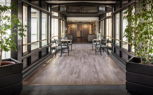 圣地亚哥蓝树创始人酒店的大楼内带桌椅的走廊