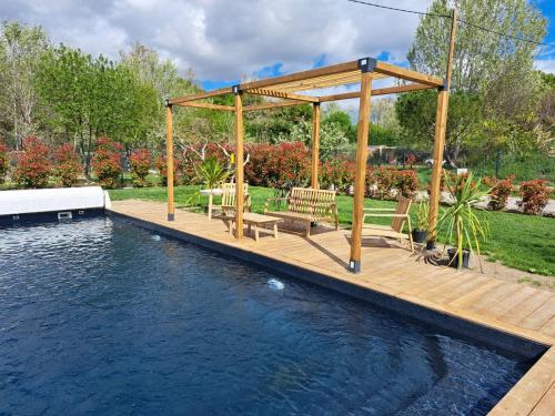 阿维尼翁Studio en campagne的游泳池旁带长椅的木甲板