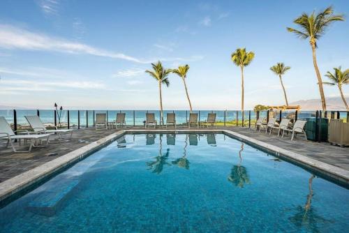 维雷亚Enjoy Your Oceanside Dream at Kihei Surfside的一座棕榈树和海洋游泳池