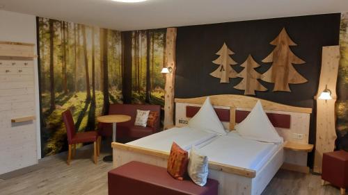 约翰乔治城Landhaus Sonnentau的一间卧室设有一张床,墙上有树木