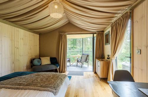 什鲁斯伯里Riverside Cabins的一间卧室配有一张床和一张桌子及椅子