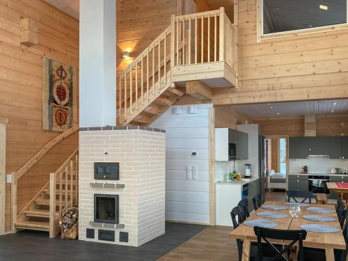 SonkaHoliday Home Villa lehtoniemi by Interhome的厨房以及带壁炉和楼梯的用餐室。